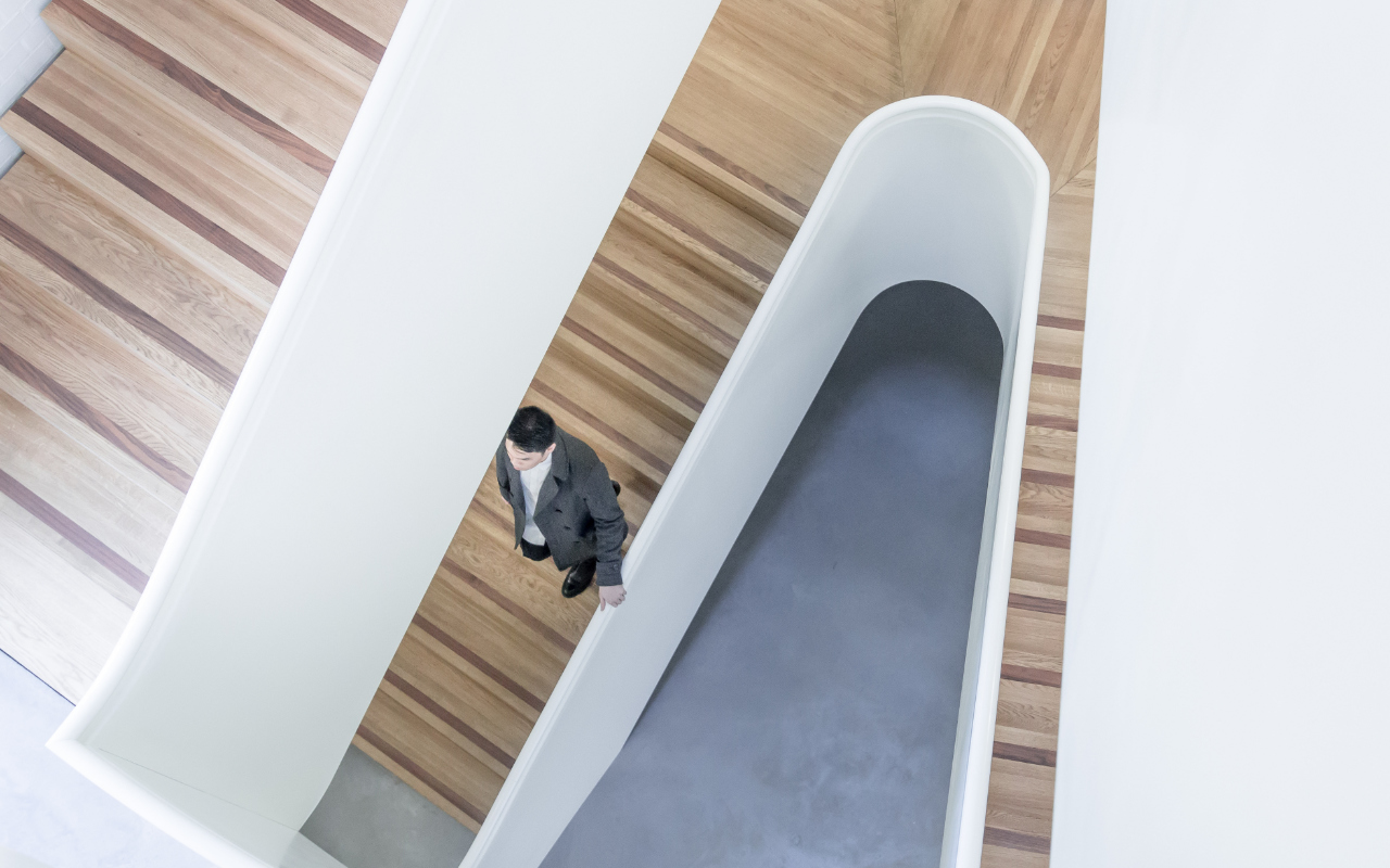 technology GRC for financial services - man walking down stairs